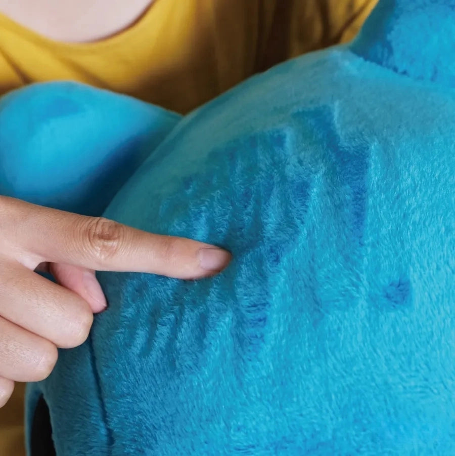 Close-Up of Giant Capoo Plush Fabric Texture: Close-up of the plush, showing a finger pointing at the soft blue fabric texture, emphasizing its high-quality plush material.