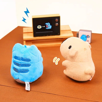 Capoo and Dogdog plush charms sitting in front of a TV, playing a retro video game together