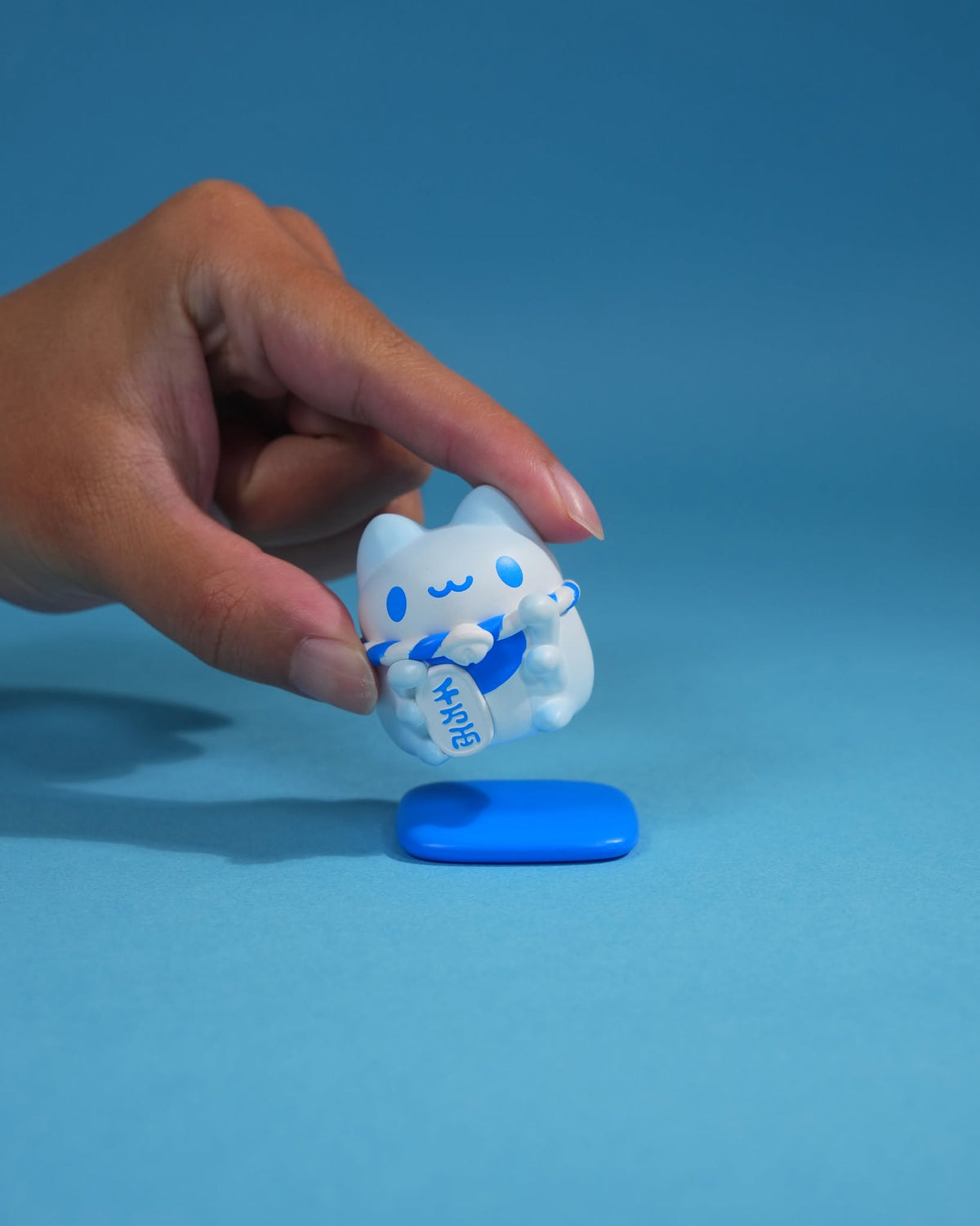 Mini Lucky Capoo Figure – Mount Fuji Blue figure shown in hand for scale