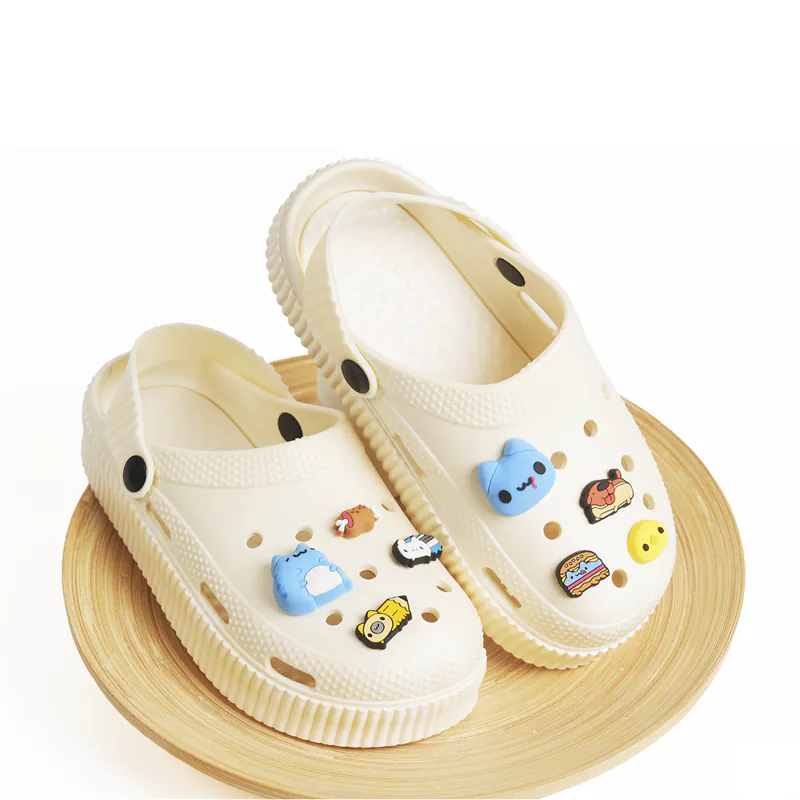 Capoo Eating Meat Croc Charms on pair of Crocs (angled view): Pair of beige Crocs with Capoo Eating Meat charms attached, arranged on a wooden plate for display, showcasing the colorful charms on the footwear.