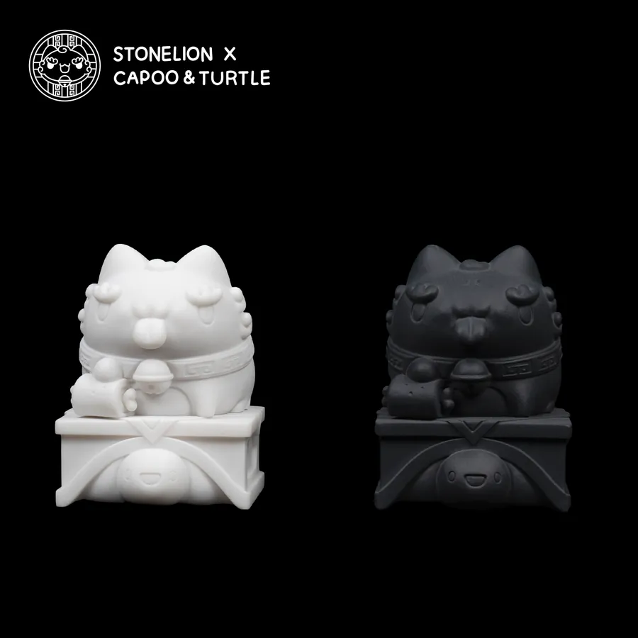 Front view of Stonelion x Capoo & Turtle sculptures: The white and black stone lion statues are displayed side by side, showing their detailed facial expressions and the turtle at their feet.