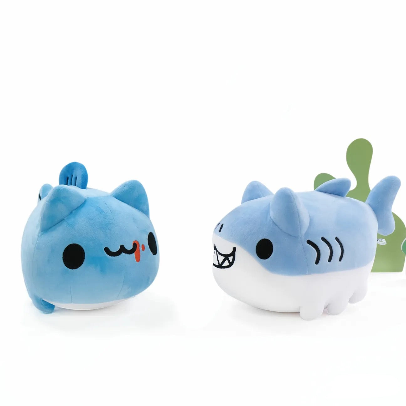 Capoo Fish Plush and Shark Bugcat Plush look at each other