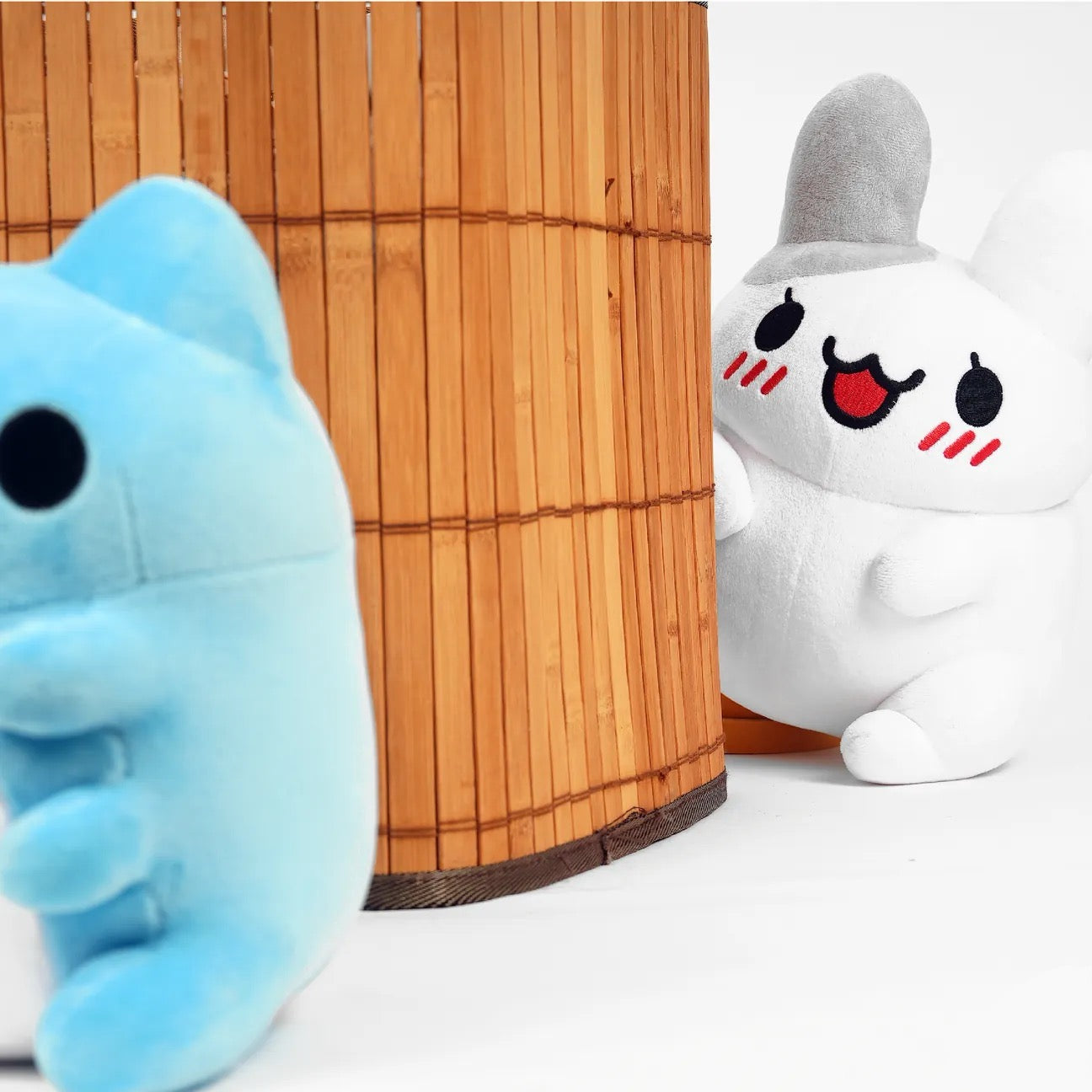 Sitting Tutu Plush peeking at Sitting Capoo Plush